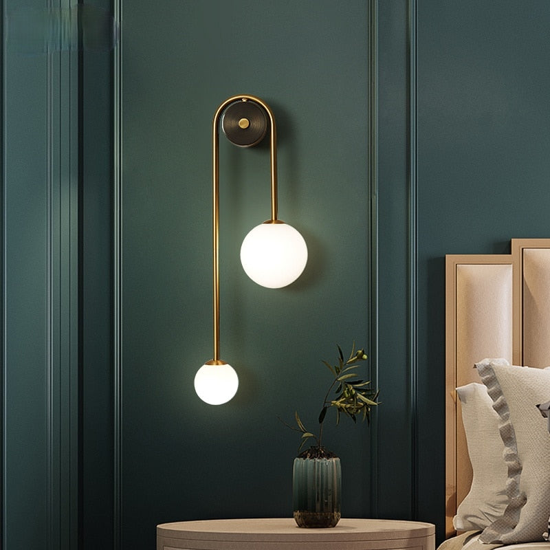 Modern Nordic gold wall sconce with glass globe shade