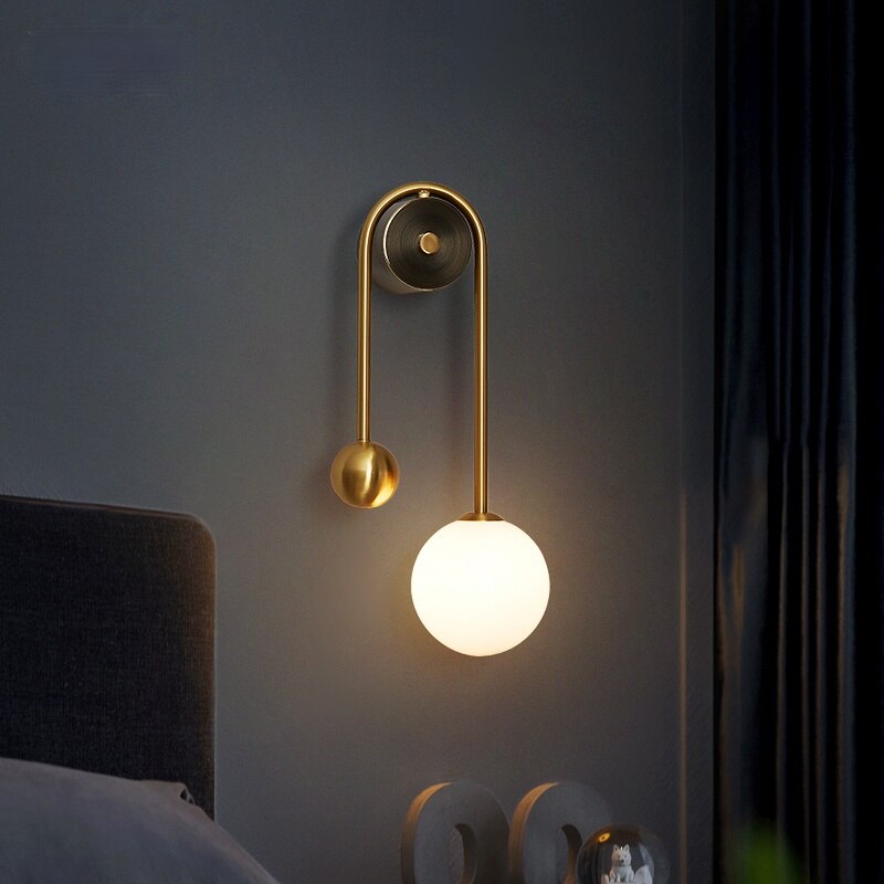 Modern Nordic gold wall sconce with glass globe shade