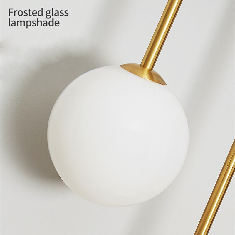 Modern Nordic gold wall sconce with glass globe shade